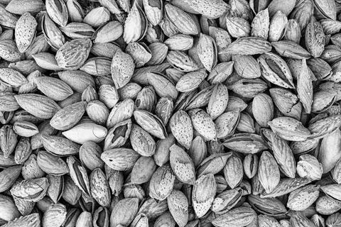 The texture of a heap of almonds in a shell. Background of healthy plant ve.. Stock Photos