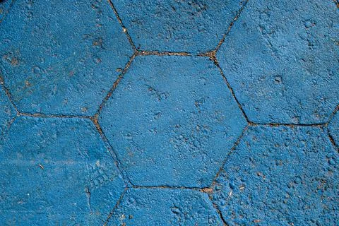 Texture of hexagonal paving slabs covered with blue paint. Pavement tile pattern Stock Photos