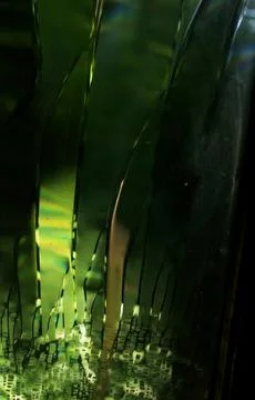 Texture highlights through thick green glass. Light through stained glass Stock Photos