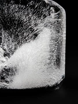 Texture of ice cube. Ice texture close-up background. Ice block on dark backg Stock Photos
