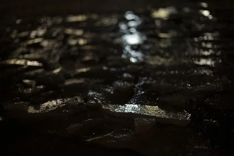 Texture of ice at night. Light on broken snow. Stock-Fotos