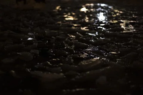 Texture of ice at night. Light on broken snow. Stock-Fotos