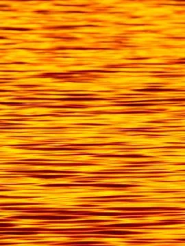 Texture image of the surface of the sunset lake Stock Photos