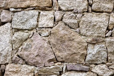 Texture of an irregular stone wall. Background. Stock Photos