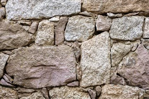 Texture of an irregular stone wall. Background. Stock Photos