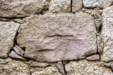 Texture of an irregular stone wall. Background. Stock Photos