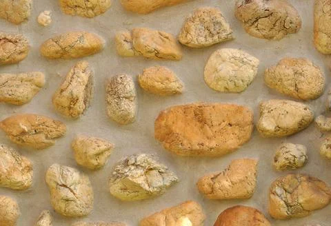 Texture of irregular stones left randomly on a cement surface Stock Photos