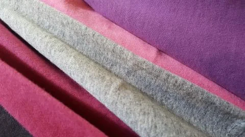 Texture. Knitted multicolored fabrics close-up, arranged diagonally. Stock Photos