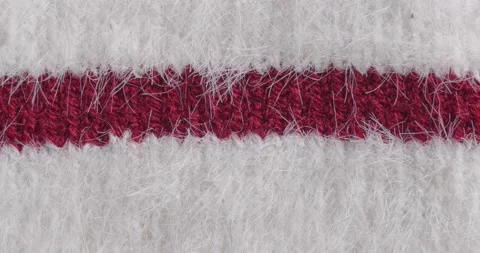 The texture of the knitted part is close-up. Macro fragment. White background. Video stock 166083442