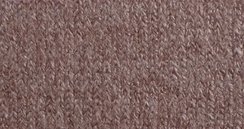 The texture of the knitted part is close-up. Macro fragment. Brown background. Vidéo 166083837