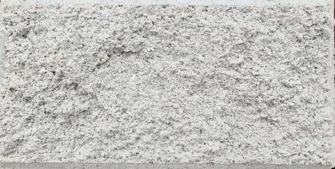 Texture of a large gray street brick block with a chamfer Stock Photos