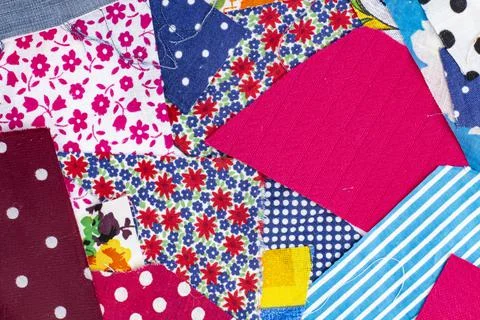 The texture of large scraps of colored fabrics as a background or backdrop, h Stock Photos