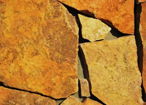 Texture of a laying of a yellow stone Stock Photos