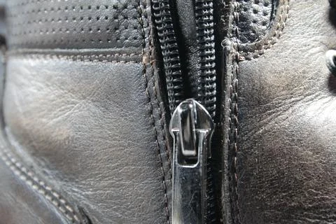 Texture of leather brown boot with zipper and rough seam Stock Photos