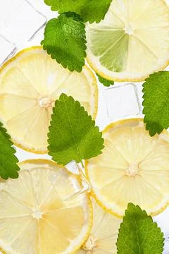 Texture with lemons, mint, ice cubes on white isolated background. Stock Photos