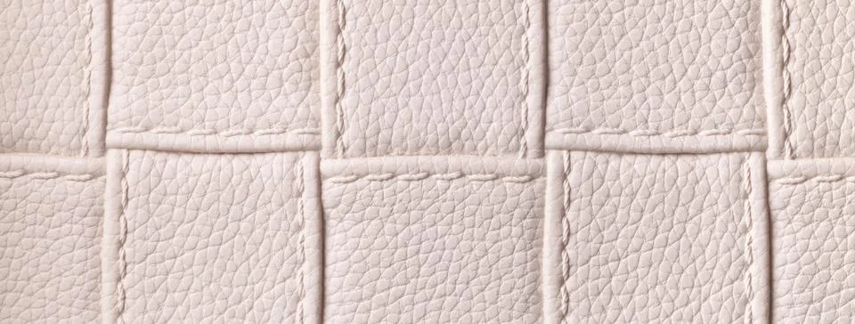 Texture light beige leather background with quilted stitched pattern, macro.  Stock Photos