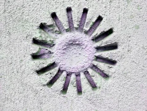 Texture of light clay in the form of the sun on the old light wall of the house Stock Photos