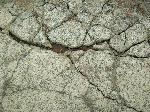 Texture of light concrete surface in cracks. Stock Photos