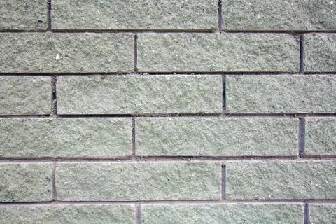 The texture of a light green brick wall in the morning light Stock Photos