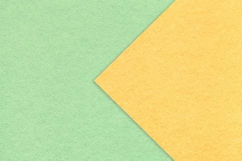 Texture of light green paper background, half two colors with yellow arrow Stockfoto's