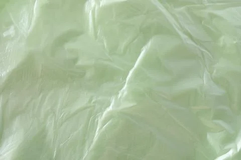 Texture of light green plastic bag as background, closeup Photos