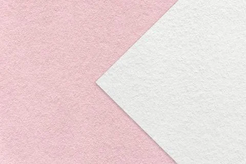 Texture of light pink paper background, half two colors with white arrow, macro. Stockfoto's