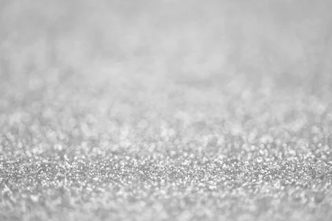 Texture of light silver glitter dust surface, luxury background with bokeh Stock-Fotos