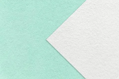 Texture of light turquoise paper background with white arrow. Mint cardboard. Stock Photos