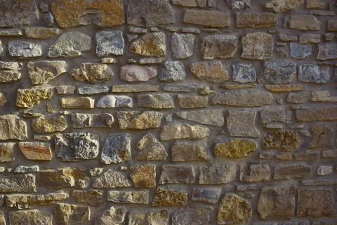 Texture lined with stone on the wall, of different shapes and shades Stock Photos