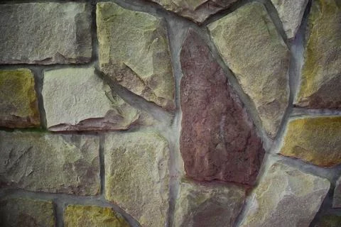 Texture lined with stone on the wall, of different shapes and shades Stock Photos