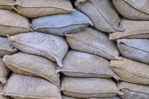 Texture lying on each other old sandbags. Piled sandbags for protection again Stock Photos