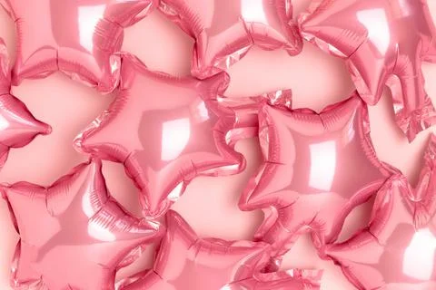 Texture made of pink star foil balloons. Stock Photos
