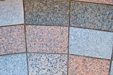 Texture of marble rectangular stone granite tiles with seams on the road. The 스톡 사진