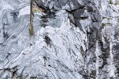 The texture of a marble rock with cracks, a pattern in the form of stripes fr Stock Photos