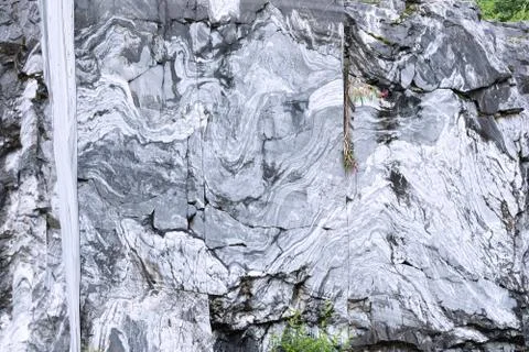 The texture of a marble rock with cracks, a pattern in the form of stripes fr Stock Photos
