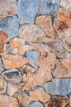 Texture of masonry of a modern stone wall made of multicolored stones in close Stock Photos