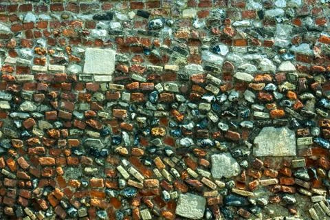 Texture of masonry, a wall built of different stones and bricks Stock Photos