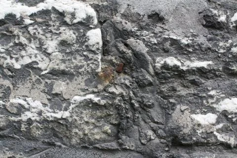 Texture Medieval stone wall with rusty nail Stockfoto's