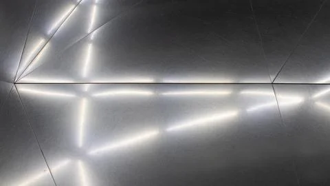 Texture of a metal surface on which white lights are reflected in an elonga.. Foto stock