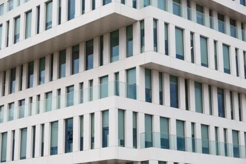 Texture of the modern facade. Perspective view of a white concrete facade with Stock Photos