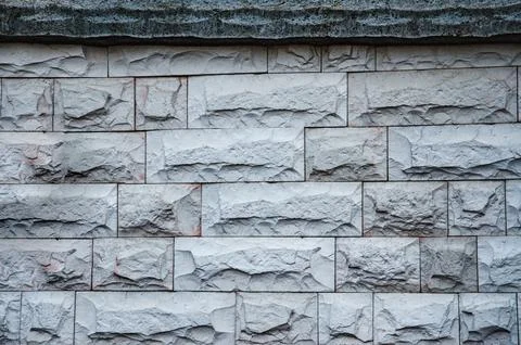 The texture of a modern gray concrete wall made of blocks, fence, fence, barr Stock Photos