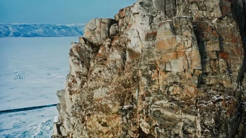 The texture of a moss-covered, centuries-old rock on Lake Baikal. Winter, cold Stock Footage 228826312