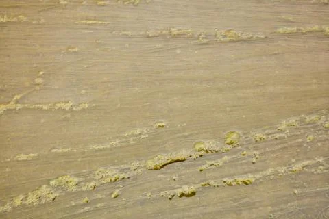 The texture of a muddy puddle with formed mud and quagmire. Stock Photos