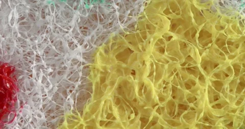 The texture of the multi-colored abrasive close-up. Macro surface sponge for Stock Footage 166494636