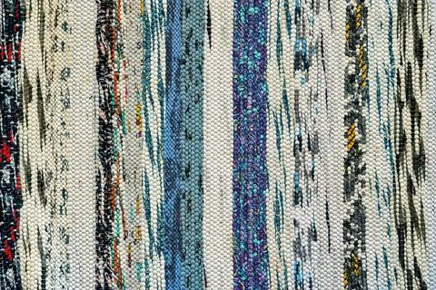Texture of a multi-colored wicker floor carpet close-up. Abstract background. Stock Photos