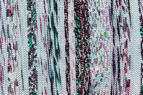 Texture of a multi-colored wicker floor carpet close-up. Abstract background. Stock Photos
