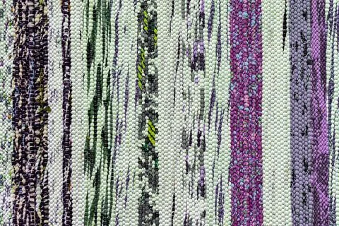 Texture of a multi-colored wicker floor carpet close-up. Abstract background. Foto stock