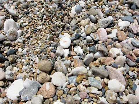 Texture multicolored sea pebbles defocus Stock Photos