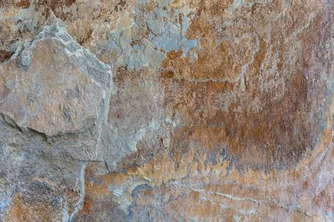 Texture of natural rusty slate stone. Rough brown and gray shale rock surface Stock Photos