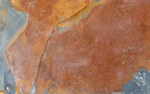 Texture of natural rusty slate stone. Rough brown and gray shale rock surface 스톡 사진